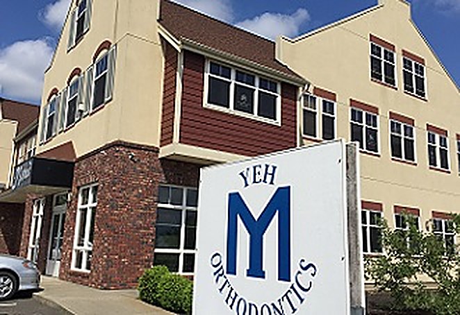 The Yeh Orthodontics monument sign, in blue, outside the Lynden office